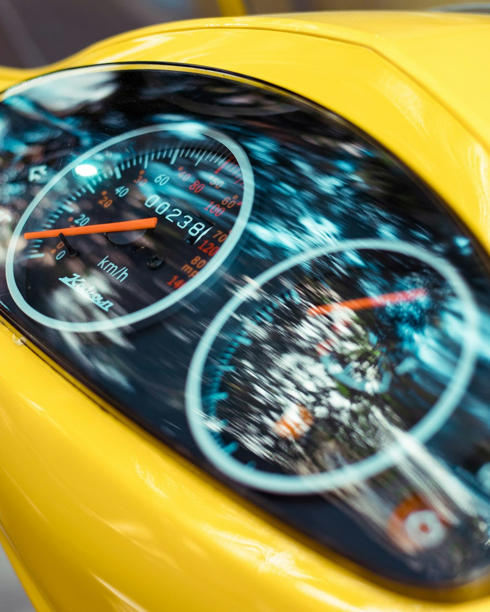 a close up of a speedometer on a yellow car