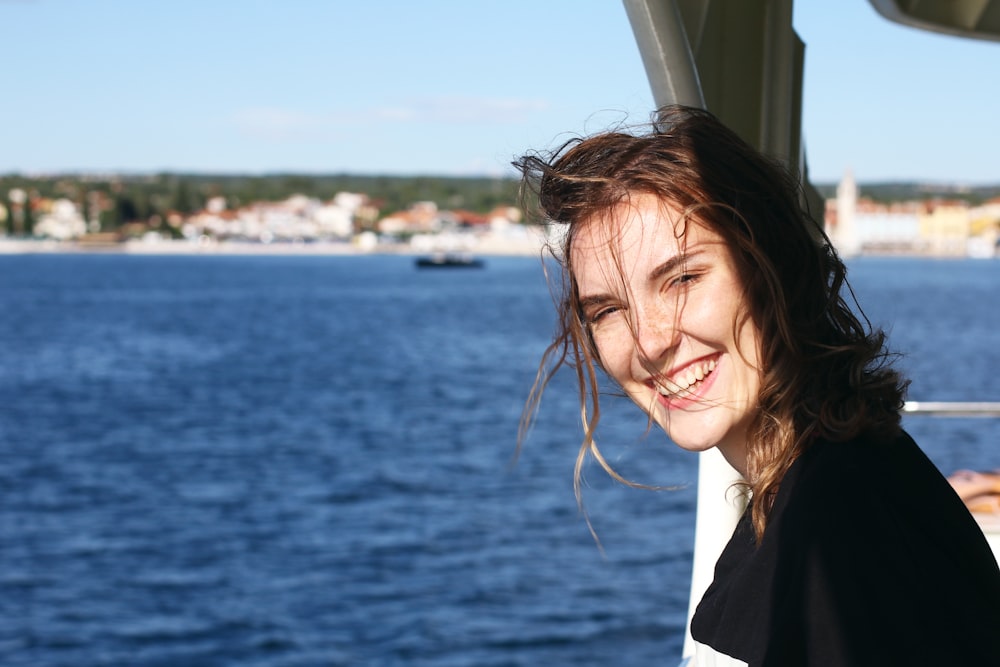 woman in black and white shirt smiling