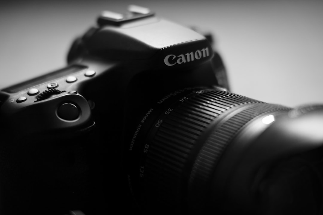 black nikon dslr camera on white table