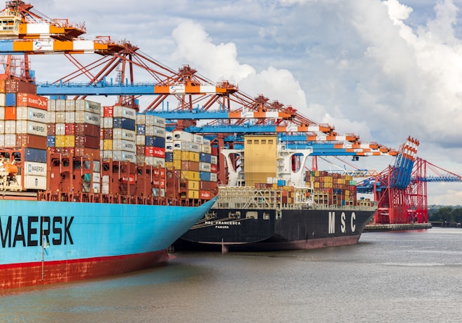 blue and red cargo ship on dock during daytime