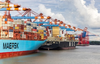 blue and red cargo ship on dock during daytime