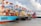 blue and red cargo ship on dock during daytime
