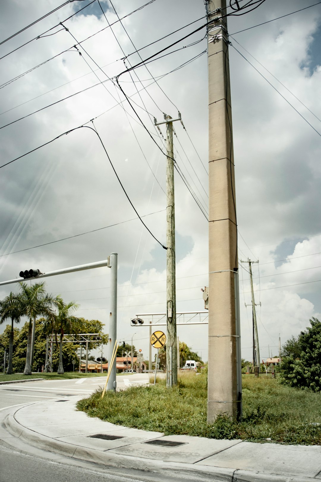 white electric post on gray concrete road during daytime
