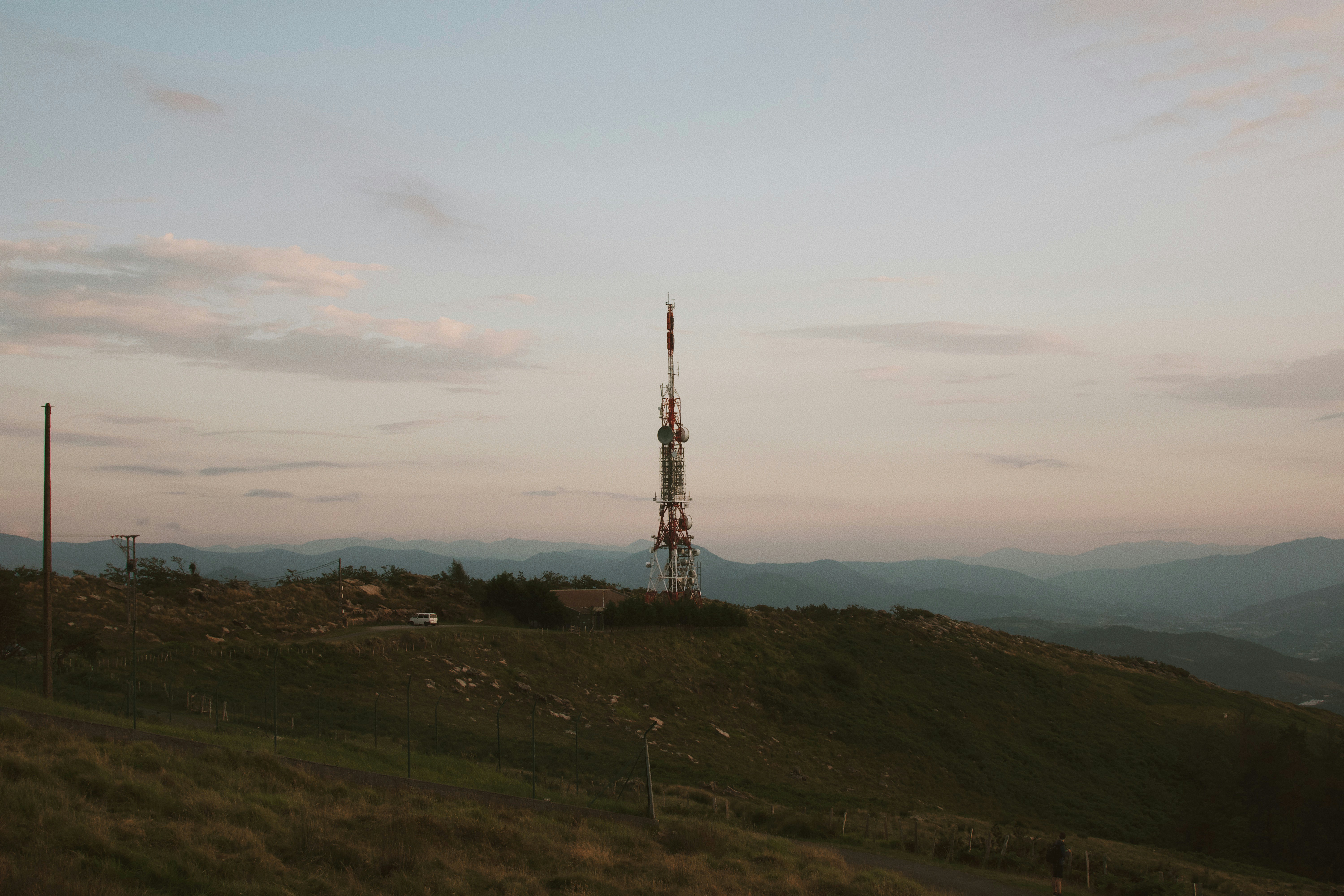 brown and white tower on green grass field under white clouds during daytime