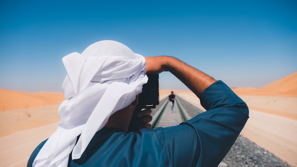 person in blue long sleeve shirt wearing white hijab