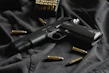 black semi automatic pistol on black textile