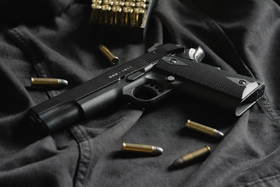 black semi automatic pistol on black textile
