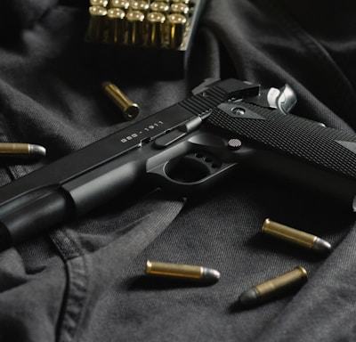 black semi automatic pistol on black textile