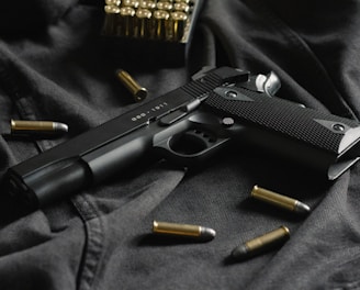 black semi automatic pistol on black textile