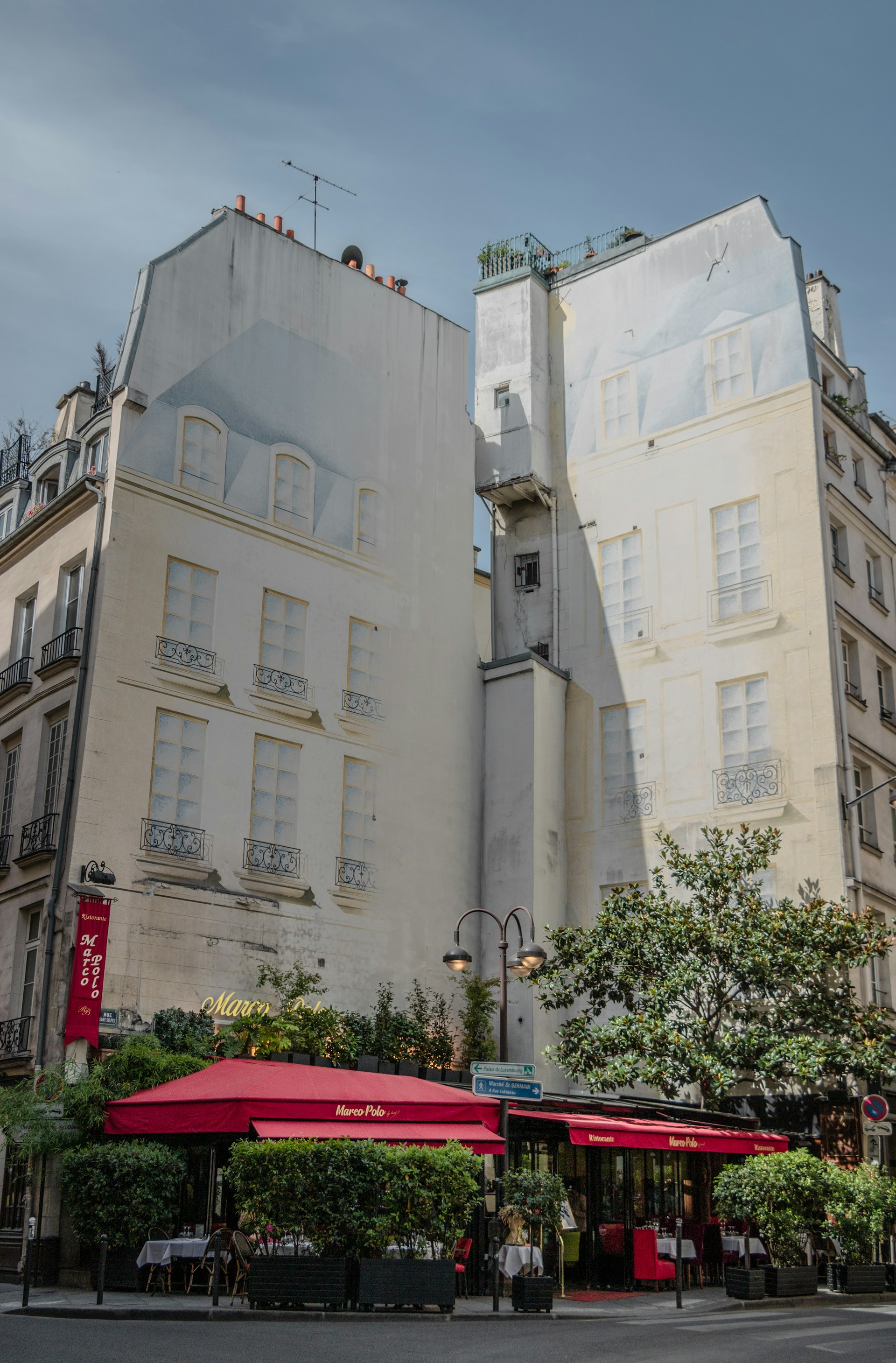 A charming European-style coffee cart set in a lush park with a fountain in the background, bathed in warm morning light.
