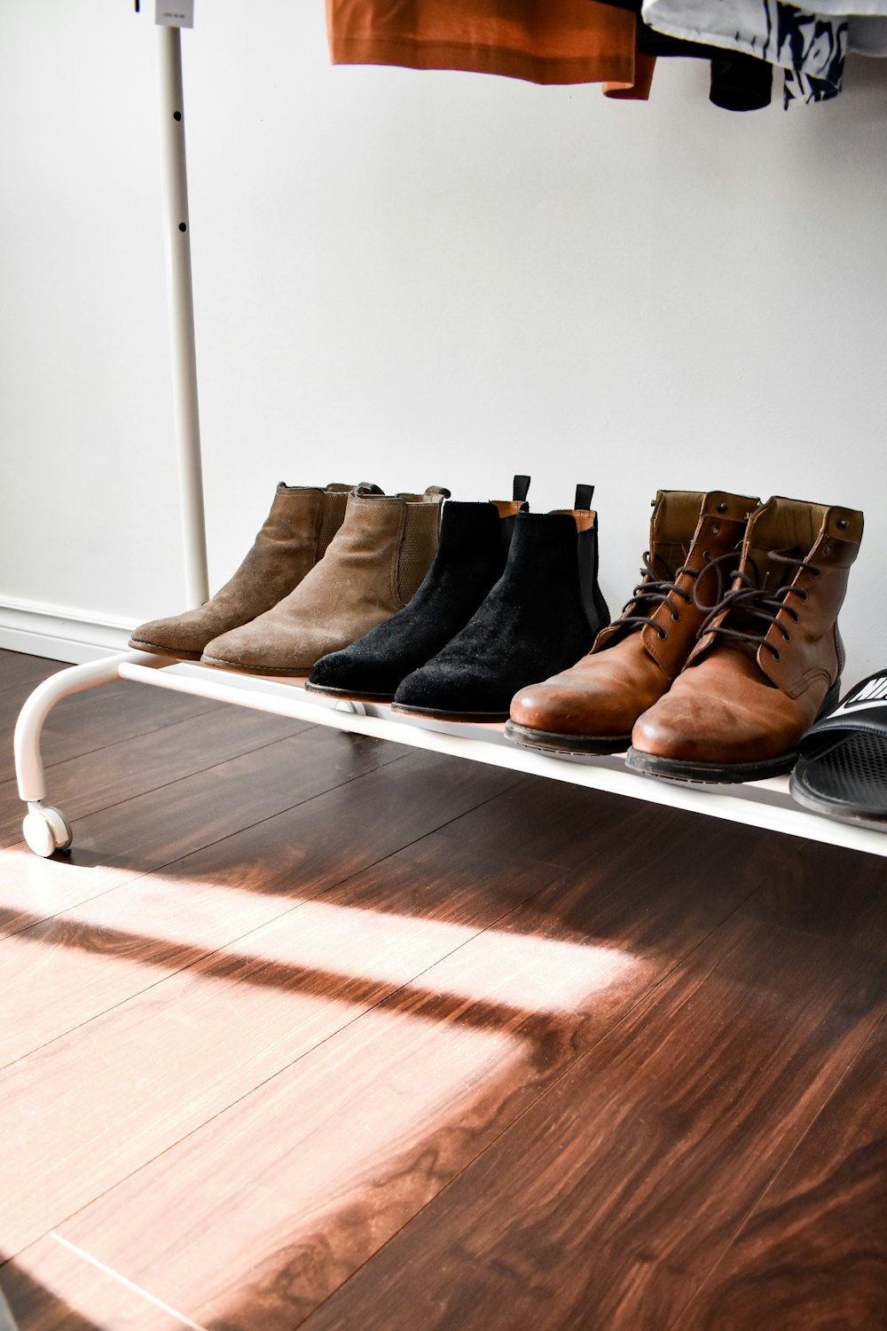 black and brown leather boots on brown wooden floor