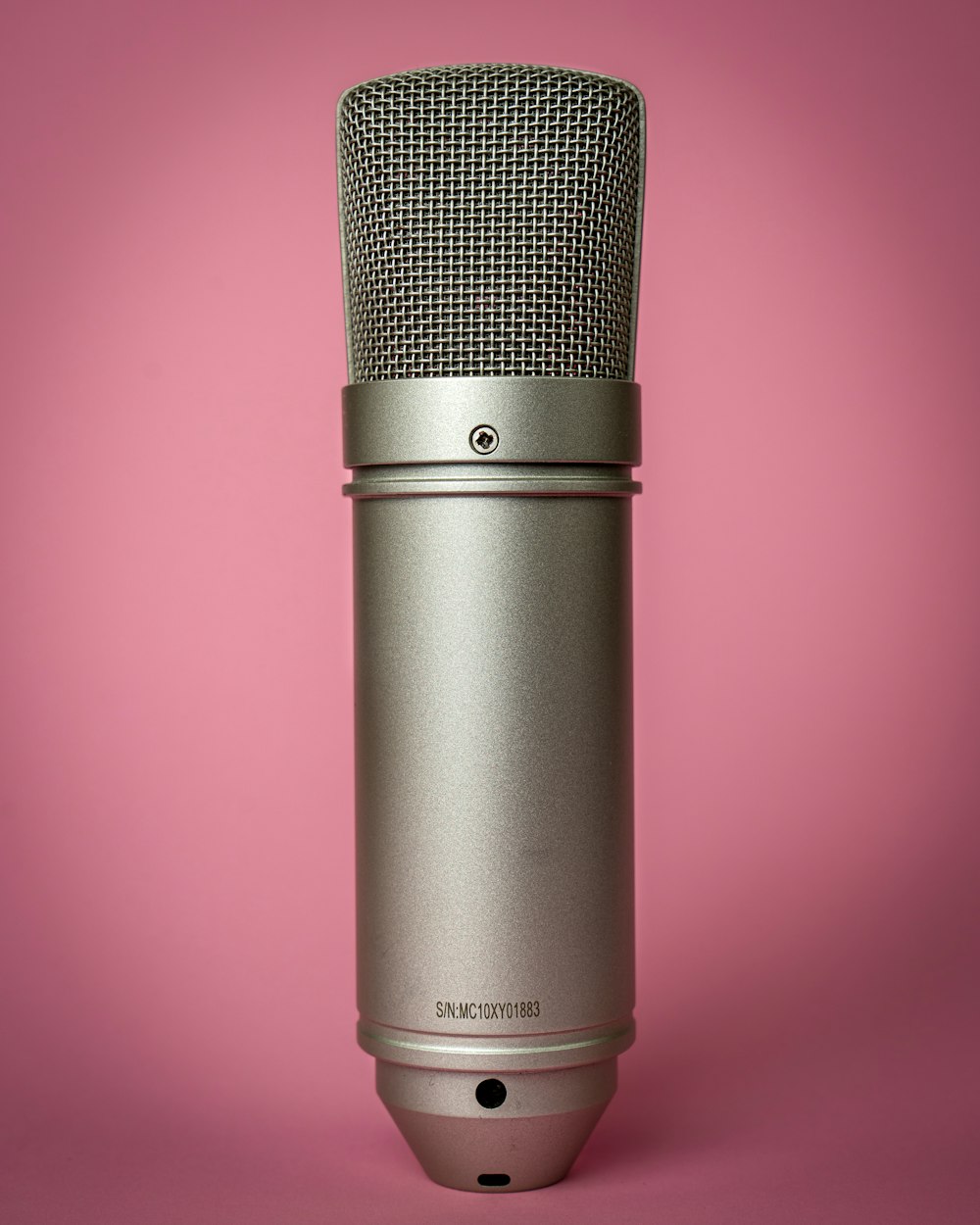 black microphone on pink background
