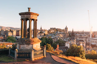 The Dugald Stewart Monument overlooking the Edinburgh skyline at golden hour