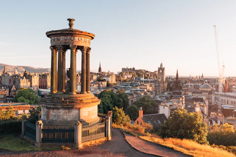 The Dugald Stewart Monument overlooking the Edinburgh skyline at golden hour