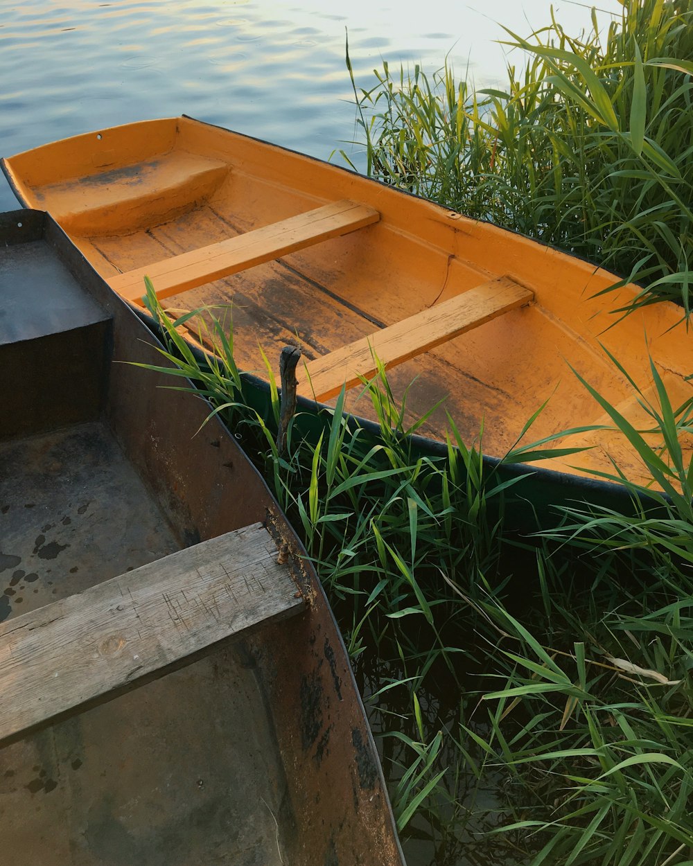 yellow boat on green grass