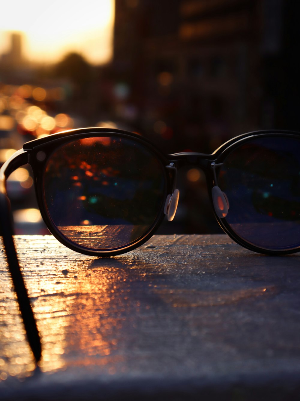 black framed sunglasses on brown wooden table