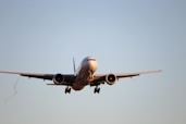 white airplane in mid air during daytime