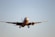 white airplane in mid air during daytime