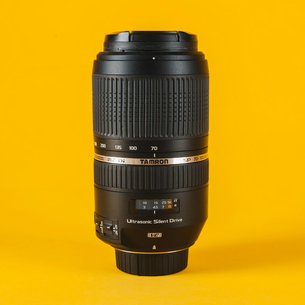 black camera lens on yellow surface
