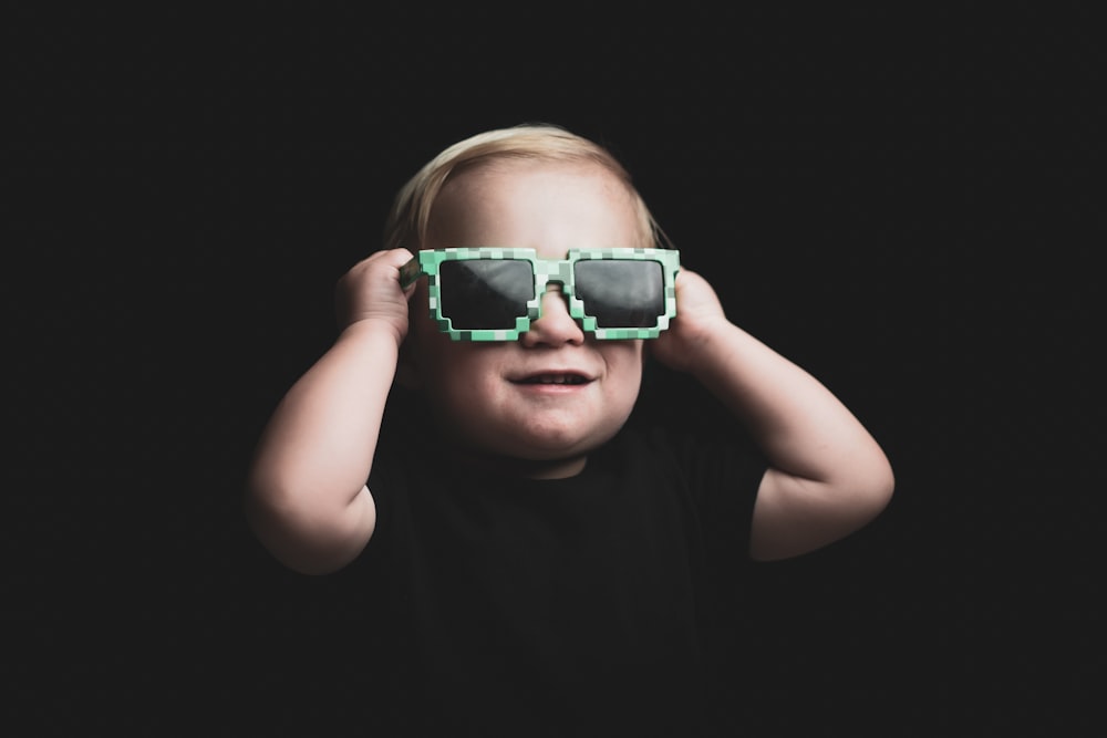 boy in green framed sunglasses
