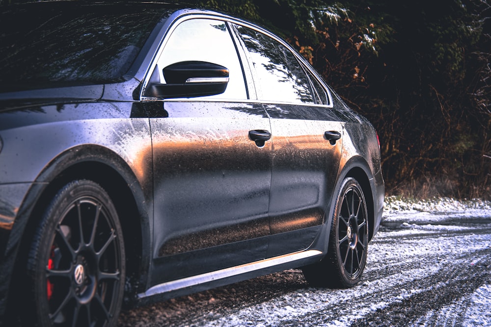 black sedan on gray asphalt road