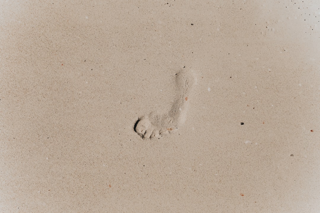 foot prints on white sand