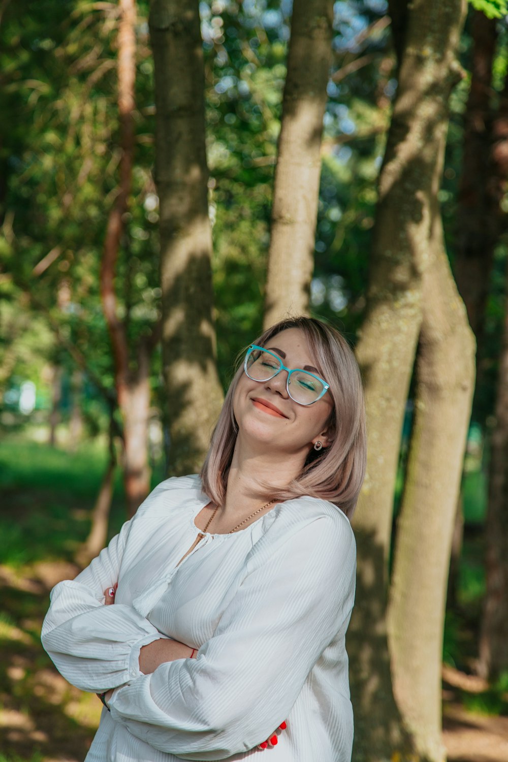 woman in white long sleeve shirt wearing eyeglasses