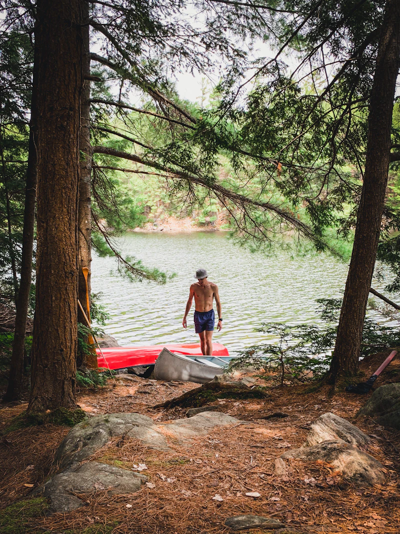 The camp's calm lakefront and wooden boathouse dock