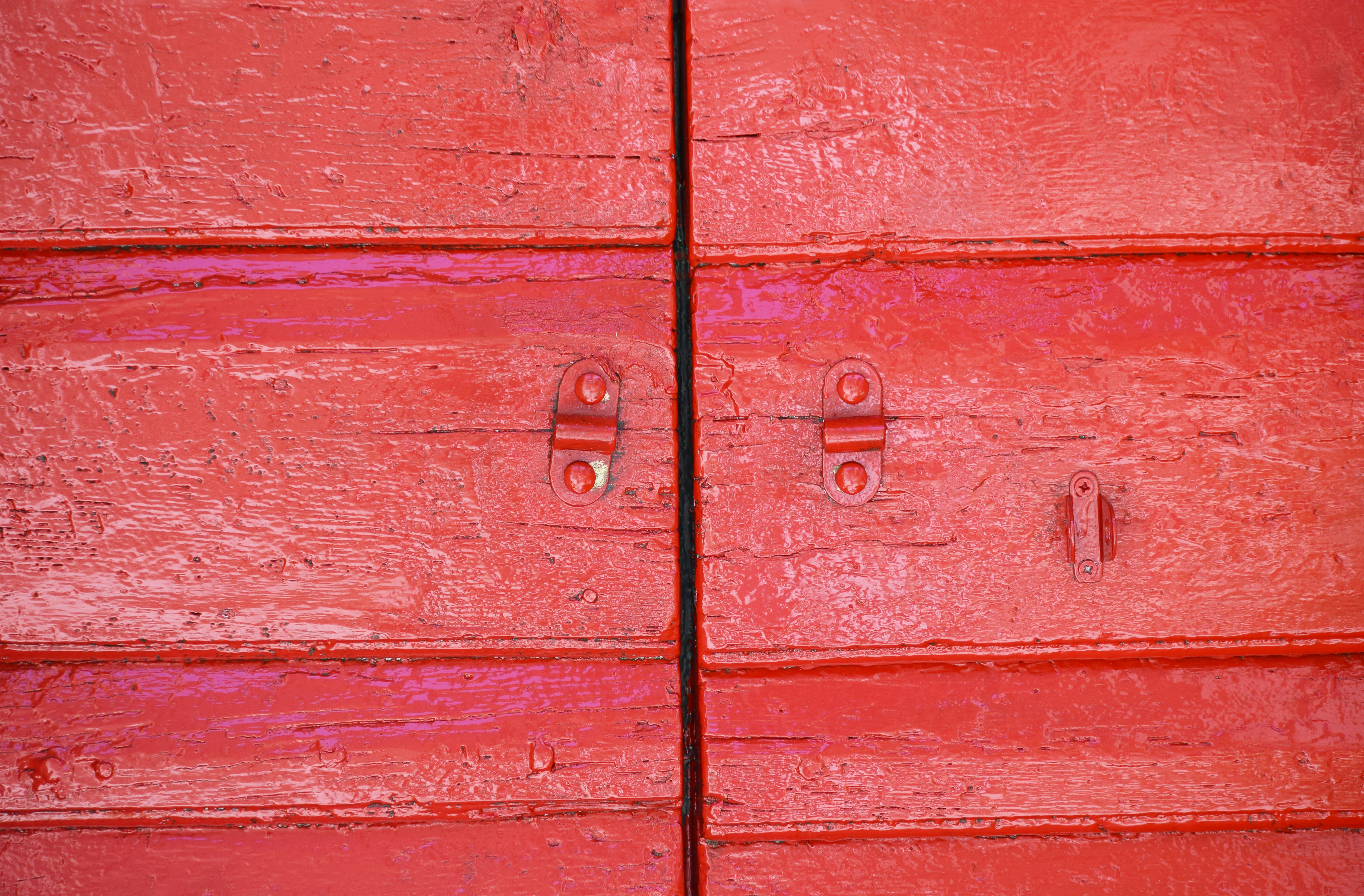 red wooden door with silver door handle