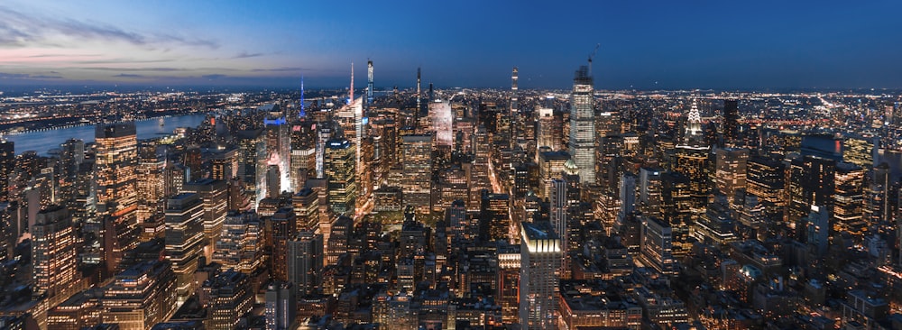 city buildings under blue sky during night time