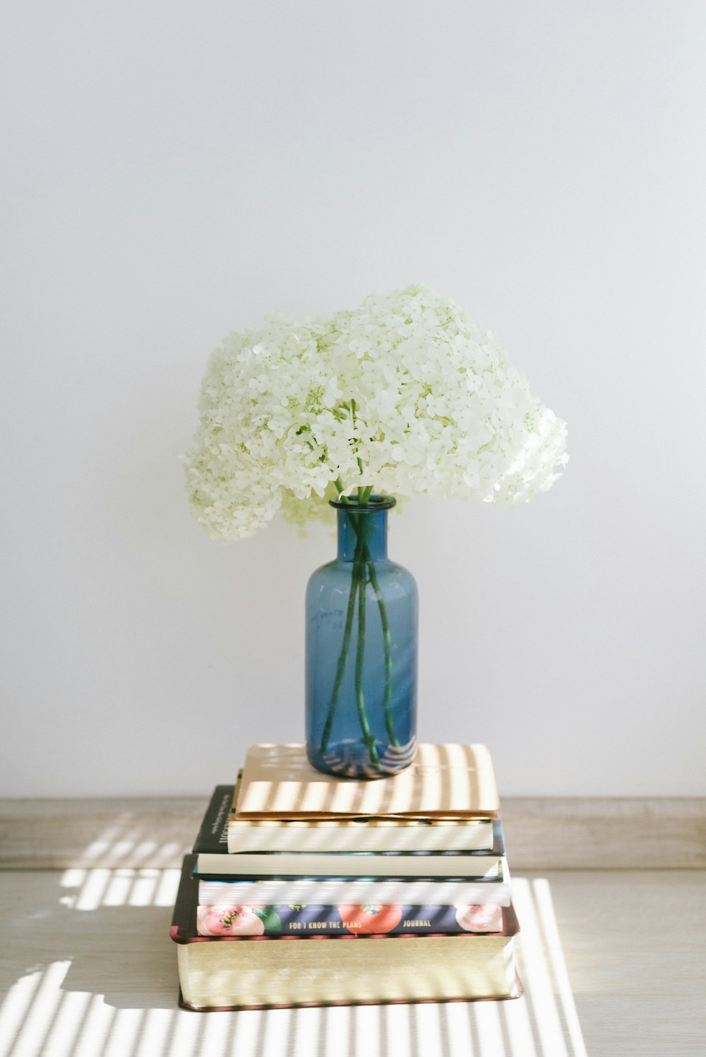 white flower bouquet on brown wooden table