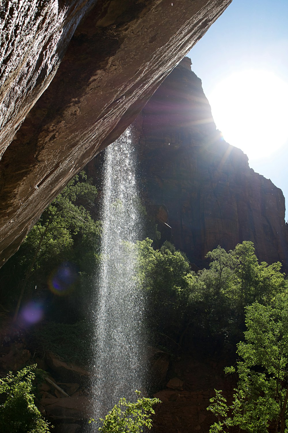 water falling from brown rock formation