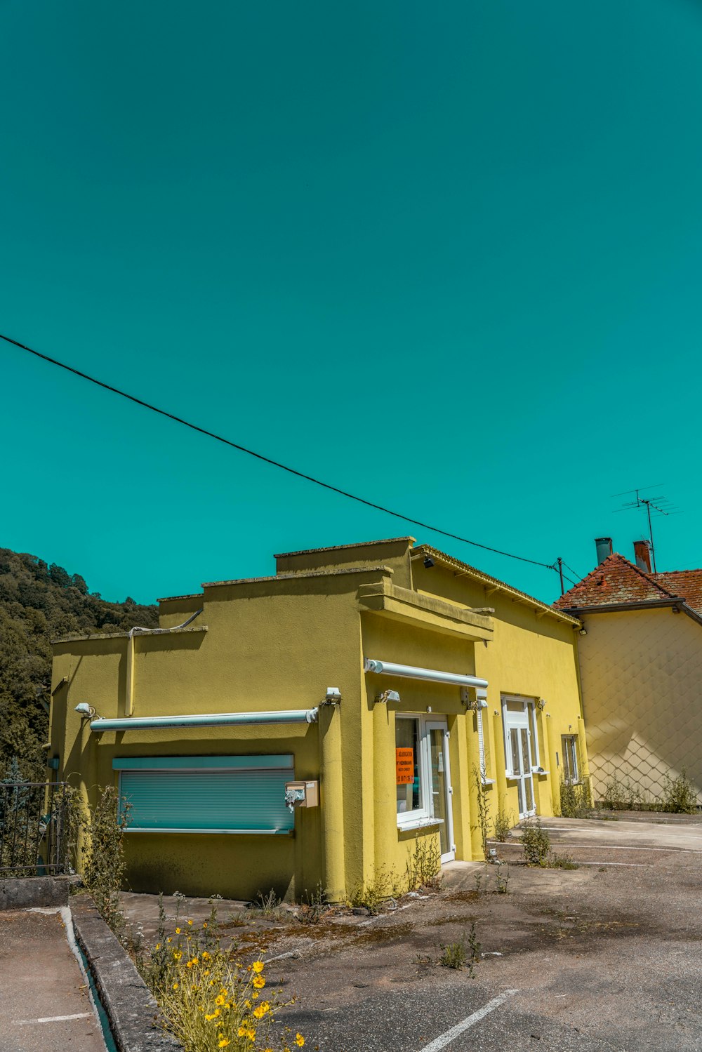 yellow concrete house under blue sky during daytime