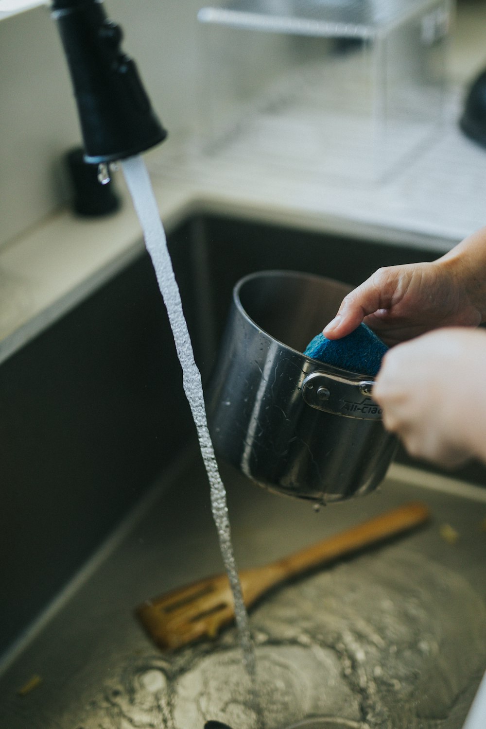 person holding blue ceramic mug