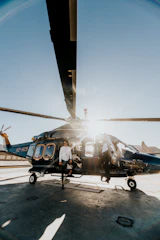 blue and white helicopter on airport during daytime