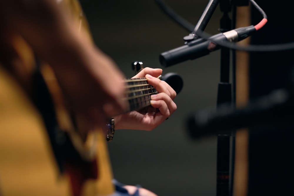 person playing guitar on stage