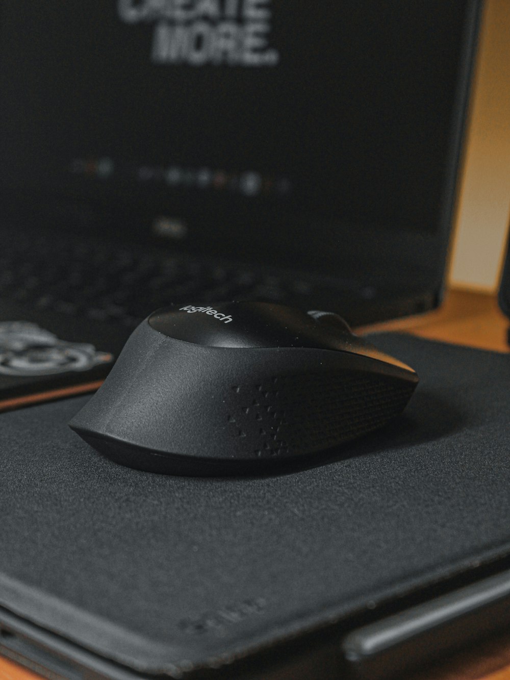 black logitech cordless computer mouse on black mouse pad