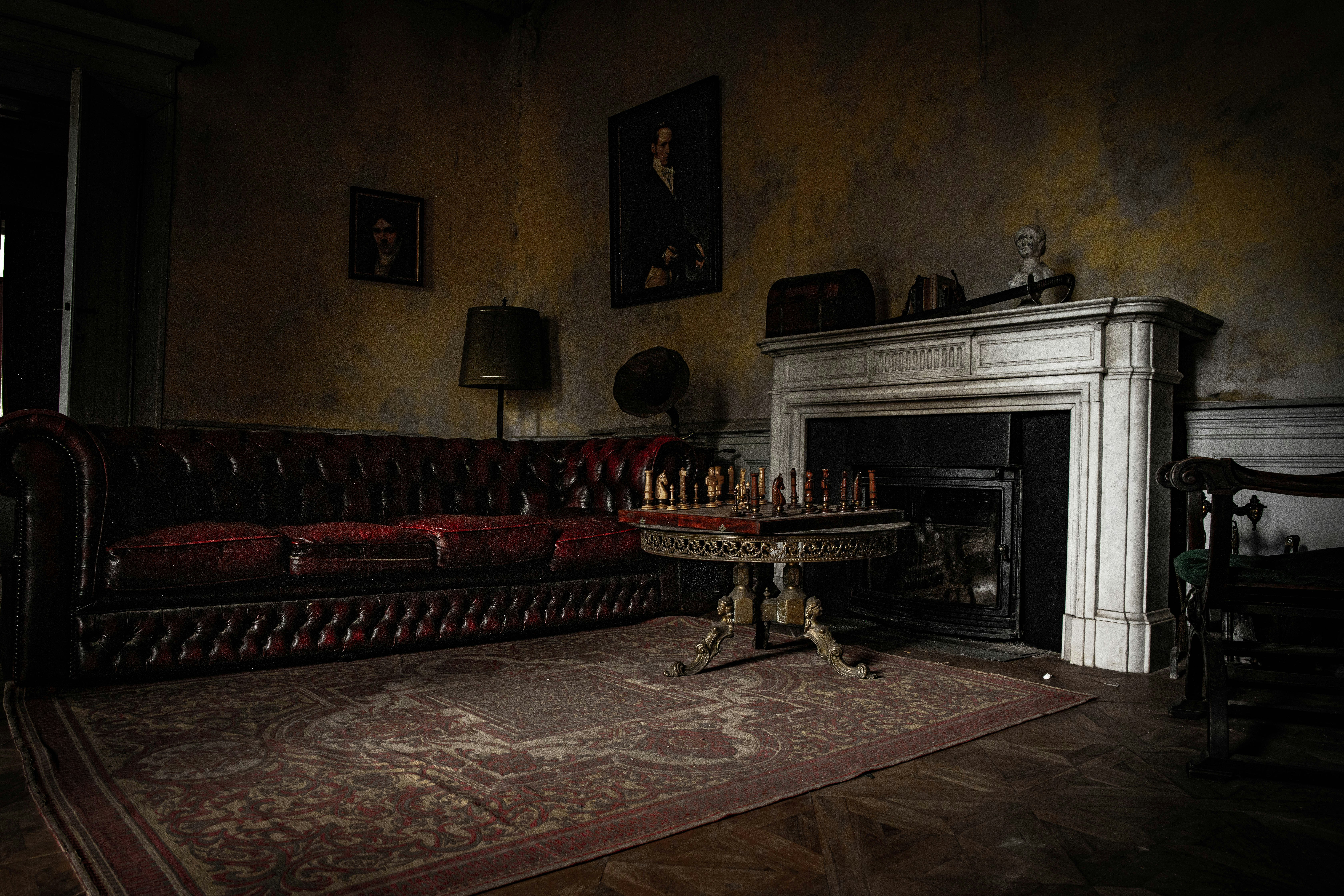 black fireplace near red and brown sofa