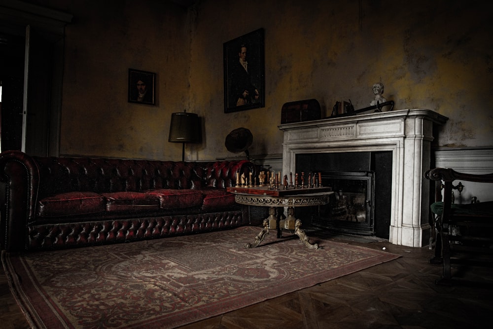 black fireplace near red and brown sofa