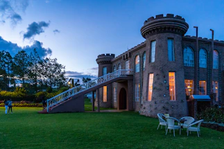 Elegant stone castle entrance with warm lighting at dusk, symbolizing trust and heritage.