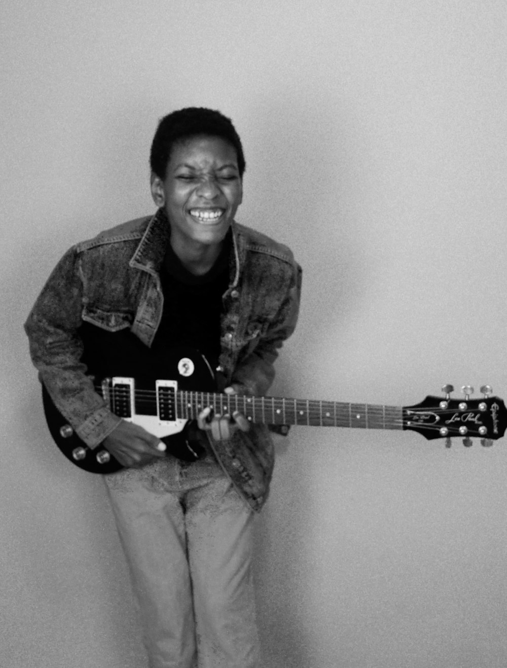 man in black button up shirt playing electric guitar