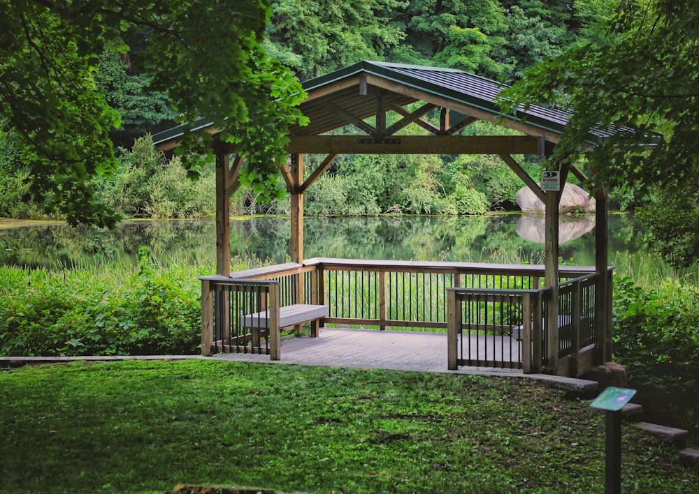 brown wooden gazebo near green trees during daytime