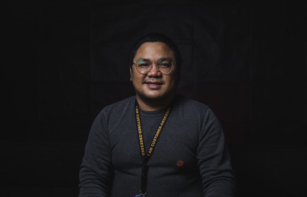 man in black long sleeve shirt wearing eyeglasses