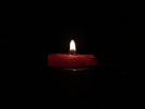 red lighted candle on dark room
