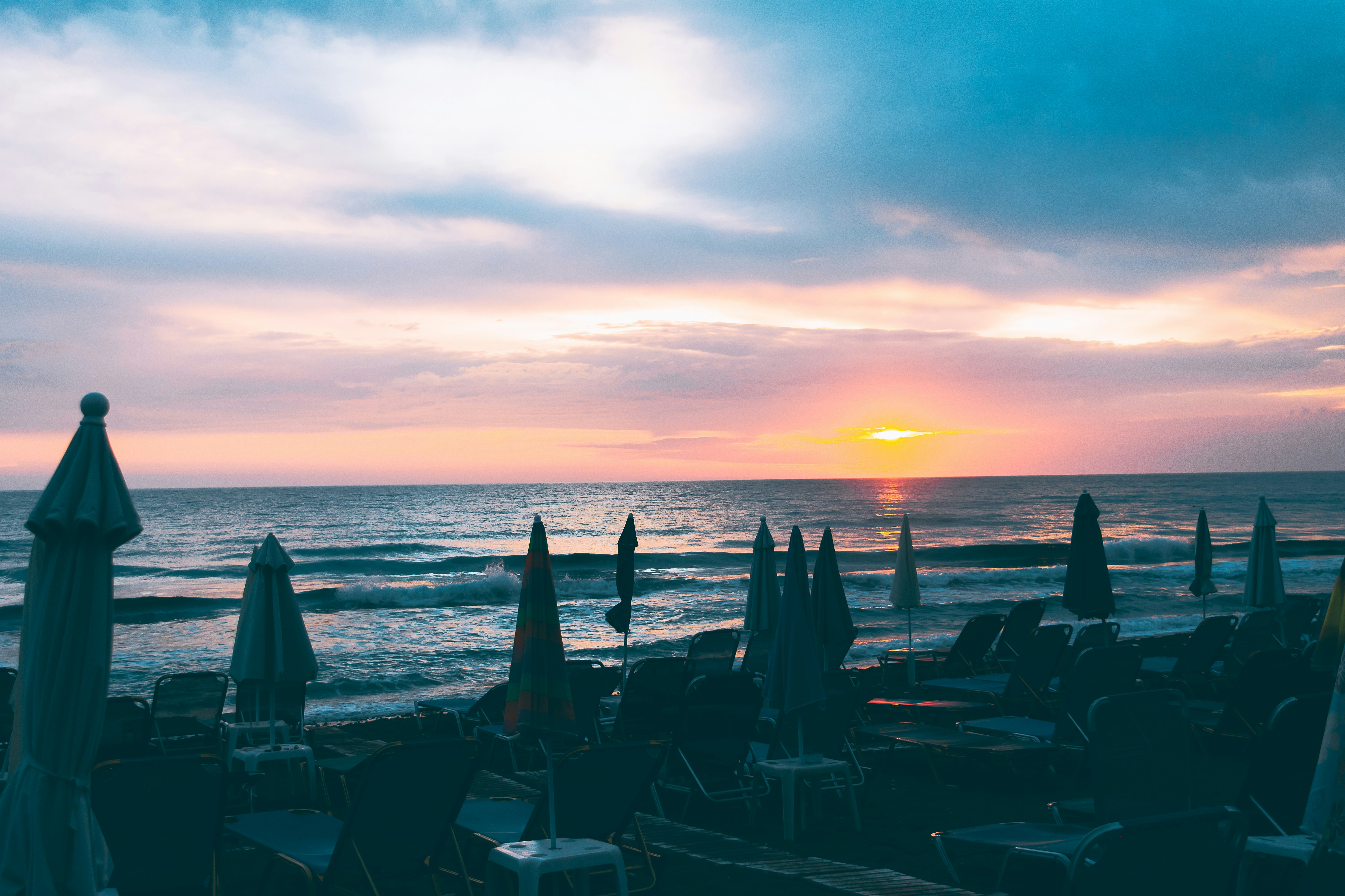 silhouette of people on beach during sunset