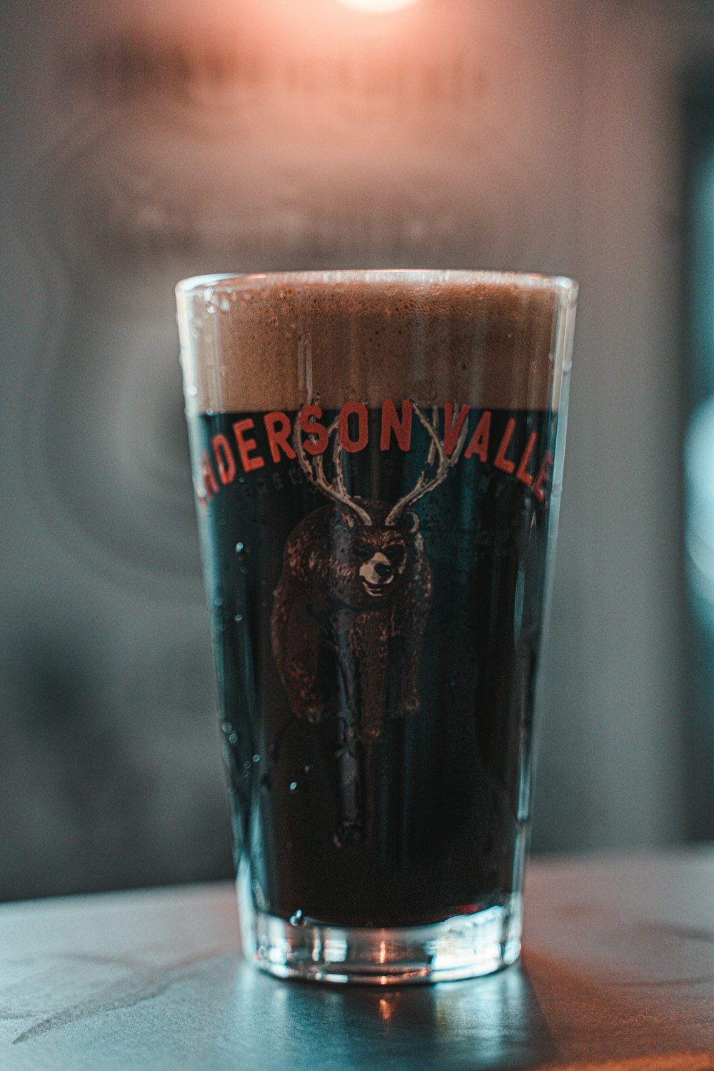 clear drinking glass with brown liquid