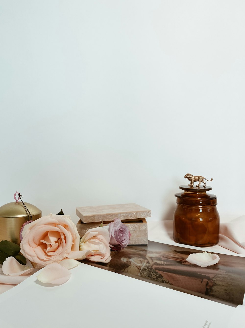 pink roses beside brown jar