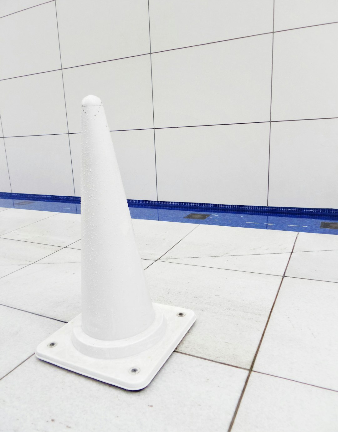 white concrete pillar on white ceramic tiles