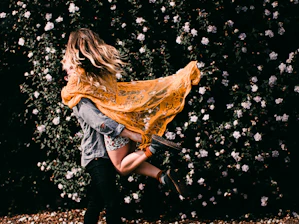 woman in blue denim jacket and blue denim jeans with gold wings