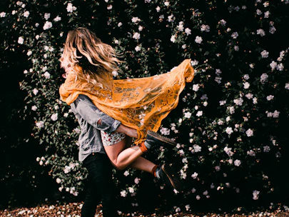 woman in blue denim jacket and blue denim jeans with gold wings